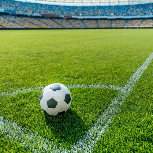 soccer ball on grass in corner kick position on soccer field stadium