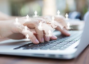 Closeup of business woman hand typing on laptop keyboard